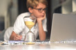 © Fabio Principe - Handsome blond kid eyeglasses doing homework with computer keeping eye time available hourglass. healthy child searching information internet; Virtual classroom; education, home-schooling concept;