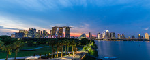Singapore Skyline Cityscape And Sunset On Marina Bay In Twilight Time . Panoramic View . Taken Photo On Marina Barrage .