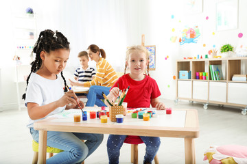 Poster - Cute little children painting at lesson indoors