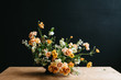 © Kate Daigneault/Stocksy - Florist in studio building a stunning floral arrangement