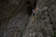 © RG&B Images/Stocksy - Young woman rock climbing inside a cave