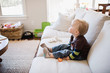 © Kelly Knox/Stocksy - toddler absorbed in a tv program