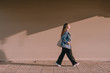 © Maki Company Limited/Stocksy - Young asian woman walking on street in the sunny day.