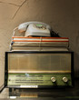 © Marco Govel/Stocksy - Antique radio, telephone and books