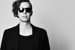 © Dmitry Lobanov - Closeup. Young successful man in stylish sunglasses, black t-shirt and black jacket. Free text space.