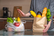 © Artem - Woman chooses a paper bag with food and refuses to use plastic. Environmental protection and the abandonment of plastic