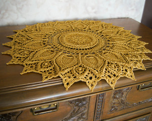 a crochet doily on the dresser