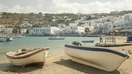 two fishing boats on the beach in the town of chora, mykonos