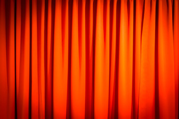 Red closed curtain with a light spot