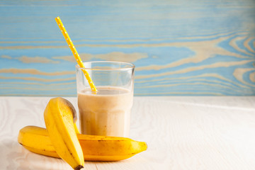 Long glasses of milkshakes with chocolate, strawberry, banana, with ice cream on white and blue background. Shakes and smoothies. Milk shake and cocktail for summer.