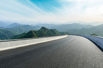 Empty asphalt road and mountains with beautiful clouds landscape