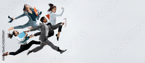 Cuadros en Lienzo Happy business women and african man dancing isolated on white.