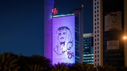 Wall Mural - Styalised image of Sheikh Tamim bin Hamad al Thani on the side of a building in central Doha