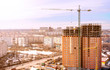 © Валерий Моисеев - Construction crane on construction site build office skyscraper building in modern City at sunset time
