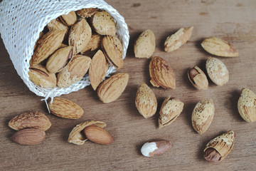 Wall Mural - Dry Almonds nuts with shell on wood table ,health food.