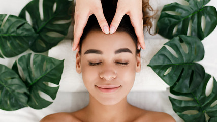 Wall Mural - Face massage. African-american girl getting spa treatment