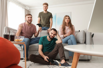 Wall Mural - Emotional friends playing video games at home