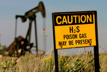 Hobbs, New Mexico, United States.  Poison Gas Sign With Oil Derrick.