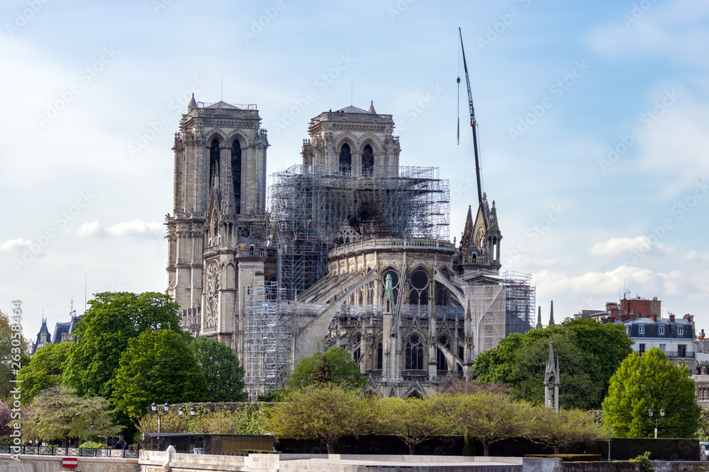 Paris, France - April 17, 2019: Notre Dame de Paris, the day after. Reinforcement work in progress after the fire, to prevent the Cathedral from collapsing. - obrazy, fototapety, plakaty 
