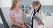 © rocketclips - Two shot of woman talking to her reassuring primary care doctor in exam room. Middle aged patient having appointment with female senior physician