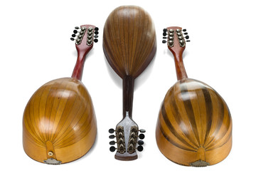 Wall Mural - Three old mandolins. View from back side. Isolated on white background.