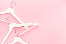 White Hangers On Pastel Pink Background