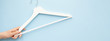 White wooden hangers on blue background