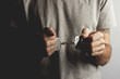 © Artvibe - young man hand handcuffs on dark background