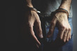 © S... - young man hand handcuffs on dark background