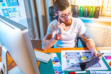 Wall Mural - graphic designer testing the application on the tablet. design for mobile devices. portrait of young