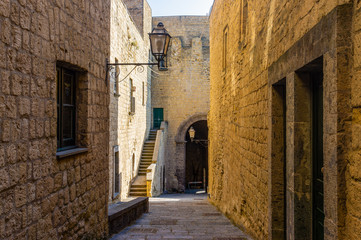 Wall Mural - Narrow way or street between walls of buildings in Castel