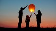 © MEDIAIMAG - Parents, child and baby silhouette rising lightning sky lantern, conceptual release hope, free dreams of happy family