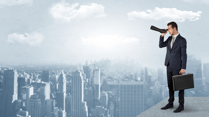 Wall Mural - businessman looking forward to a city with binoculars from skyscraper concept