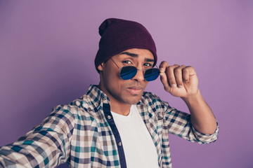 Wall Mural - Close up photo portrait of confident modern blogger influencer on instagram making taking picture adjusting round specs isolated violet background