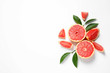 © New Africa - Grapefruits and leaves on white background, top view. Citrus fruits