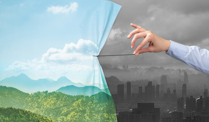 hand pulling nature cityscape curtain to gray cityscape, environmental protection concept