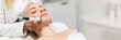 Leinwandbild Motiv Beautiful woman in professional beauty salon during photo rejuvenation procedure