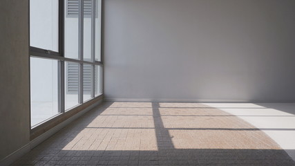 Sunlight and shadow on surface of cobblestone pavement floor with glass wall and gray wall background in interior architecture design concept