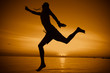 © LI QING - silhouette of a man jumping on the beach
