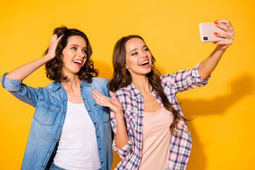 Wall Mural - Close up photo cute carefree teens teenagers blog bloger make photo greeting touch head hair chill free time weekends childish hipsters wear checked jeans shirts outfit isolated yellow background