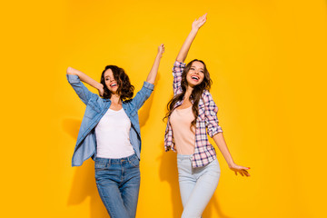 Portrait of cute lovely teen teenagers enjoy glad content spring free time weekends holidays raise hands arms dream dreamy candid dressed plaid modern outfit isolated on yellow background 