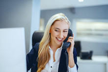 Smiling Beautiful Caucasian Businesswoman Having Phone Call While Sitting In Office. Great Minds Think Independently, Not Alike.