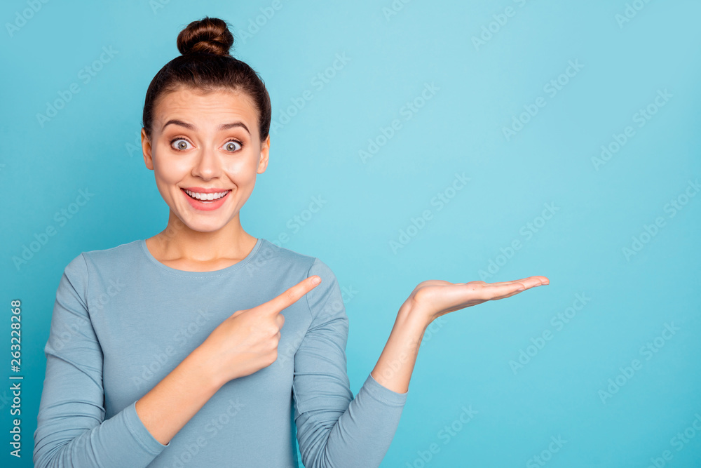 Close up photo beautiful she her lady hold open arm hand palm indicate empty space perfect proposition buy buyer low prices black friday wear casual sweater pullover isolated blue bright background - obrazy, fototapety, plakaty 