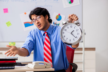 Young male financial manager working in the office 