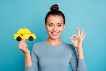 Wall Mural - Close up photo top-knot positive satisfied cheerful hipster advertise choose advert feedback hold hand paper card yellow taxi car cab route trendy stylish beautiful shirt isolated blue background 