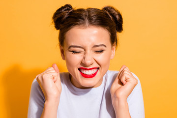 Wall Mural - Close-up portrait of her she nice-looking attractive lovely cheerful cheery optimistic teen girl holding fists isolated over bright vivid shine yellow background
