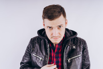 Wall Mural - Man in trendy jacket on white background Portrait of young male in leather jacket zipping up and smiling at camera on white background