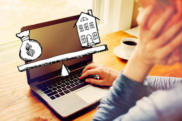 Wall Mural - House and money on the scale with man using a laptop computer