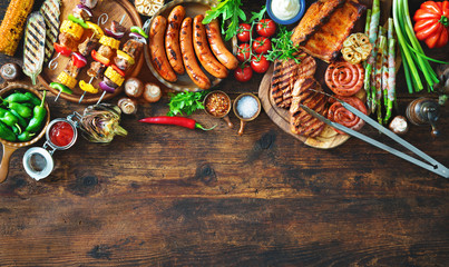 Wall Mural - Grilled meat and vegetables on rustic wooden table