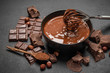 © Anatoly Repin - ceramic bowl of chocolate cream or melted chocolate and pieces of chocolate on dark concrete background